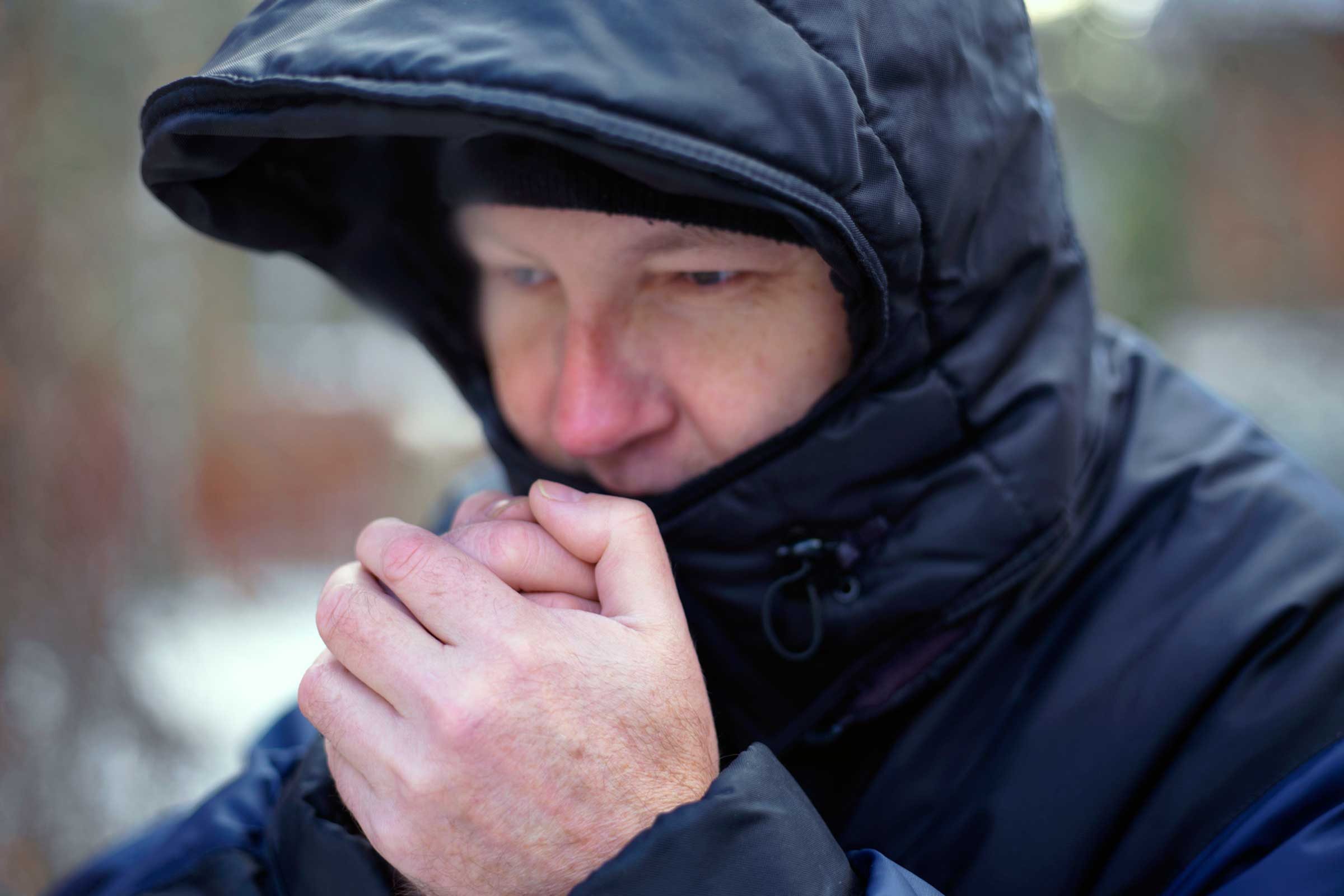 Man in winter coat looks cold