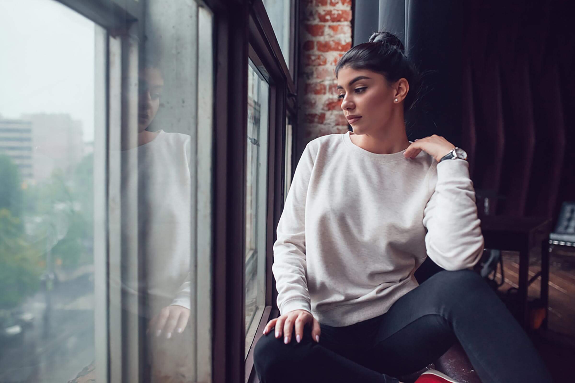 thoughtful woman looking out window