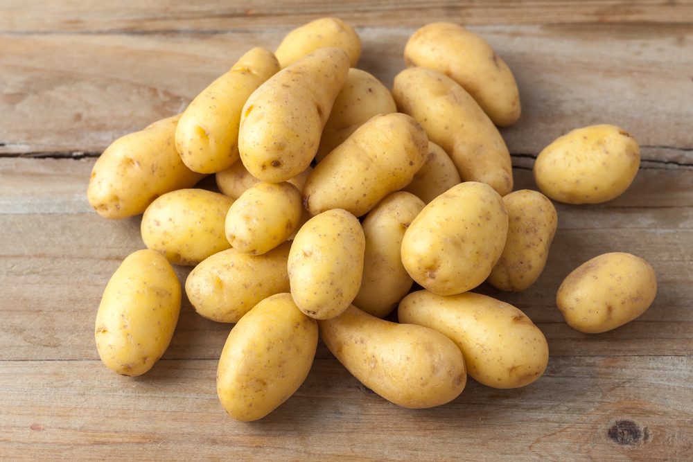 raw baby potatoes on rustic wooden background