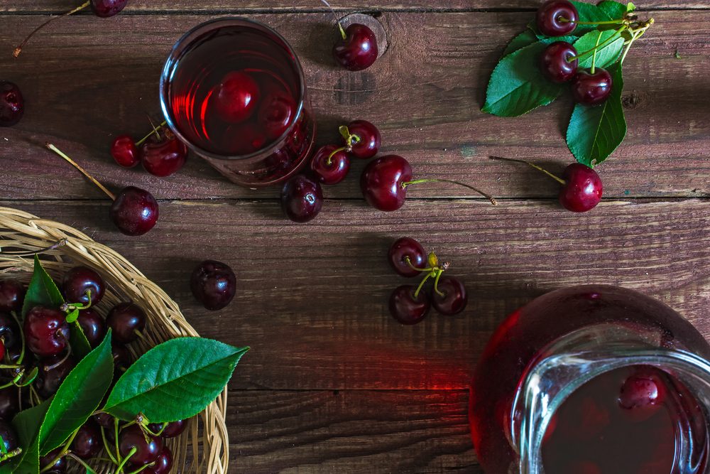 bowl of cherries, cherries on table, and cherry juice