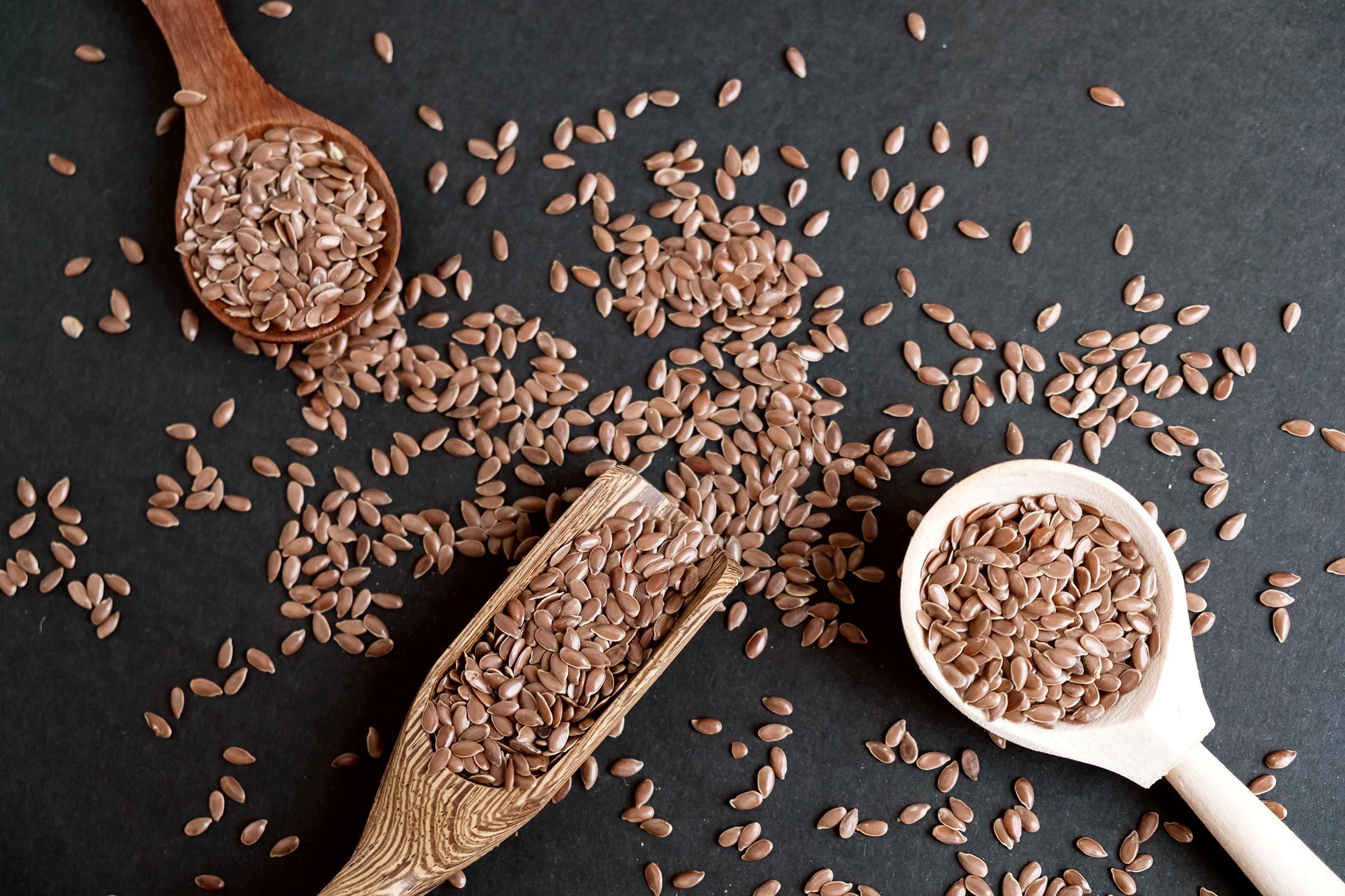 flaxseeds in spoons and on table