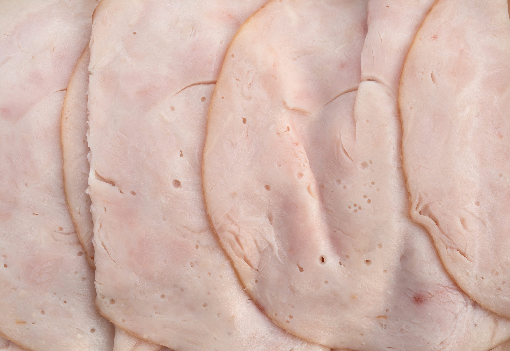 Close view of slices of oven roasted turkey breast luncheon meat