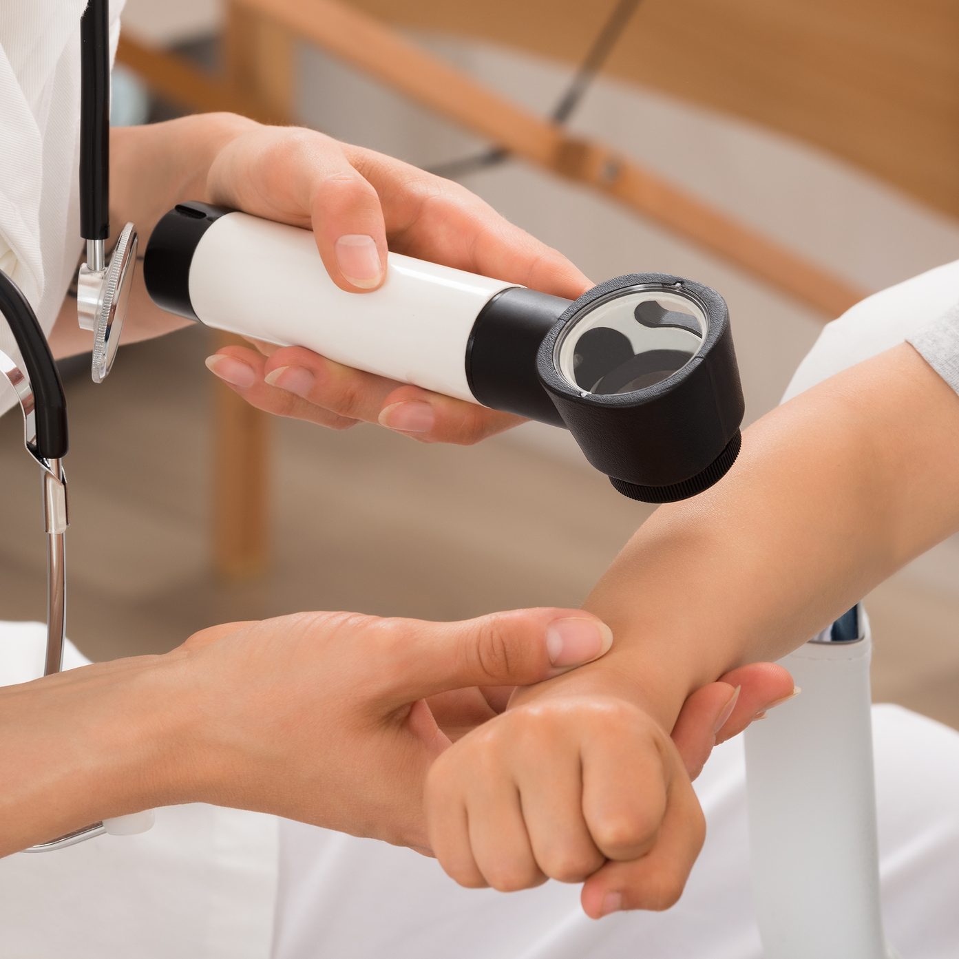 Doctor Examining Skin Of Child Patient